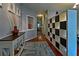 Elegant foyer with hardwood floors, stylish decor, and a custom storage unit at 440 Berckman Nw Dr, Lilburn, GA 30047