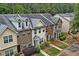 Aerial view of townhomes with well-manicured lawns and mature trees offering a serene living environment at 440 Berckman Nw Dr, Lilburn, GA 30047