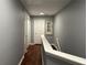 Second floor hallway featuring hardwood floors, closet, and bedroom door access at 440 Berckman Nw Dr, Lilburn, GA 30047