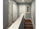 Second floor hallway featuring hardwood floors, closet, and stairway access at 440 Berckman Nw Dr, Lilburn, GA 30047