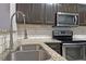 Charming kitchen features granite countertops, stainless steel sink, and modern appliances at 440 Berckman Nw Dr, Lilburn, GA 30047