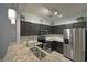 Updated kitchen with granite countertops, stainless appliances, and pendant lighting at 440 Berckman Nw Dr, Lilburn, GA 30047