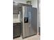 Stainless steel refrigerator next to cabinets with subway tile backsplash in modern kitchen at 440 Berckman Nw Dr, Lilburn, GA 30047