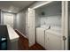 Second floor laundry room area with a washing machine and dryer hookups next to the hallway at 440 Berckman Nw Dr, Lilburn, GA 30047