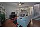 Cozy living room featuring modern decor, fireplace, and open access to the kitchen and stairway at 440 Berckman Nw Dr, Lilburn, GA 30047