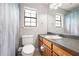 Bright bathroom with window, featuring a single sink vanity and toilet at 522 Knollwood Dr, Stockbridge, GA 30281