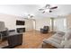 Inviting living room featuring a fireplace, hardwood floors, and ceiling fans at 522 Knollwood Dr, Stockbridge, GA 30281