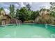 Sparkling pool with ladder and deck, surrounded by trees and lush vegetation at 522 Knollwood Dr, Stockbridge, GA 30281