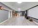 Large basement featuring a home theater area, storage area, and LVP flooring at 1727 Shire Village Dr, Sugar Hill, GA 30518