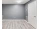 Finished basement with a white door, gray walls, and vinyl floors at 1727 Shire Village Dr, Sugar Hill, GA 30518
