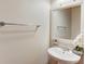 Pedestal sink and mirror in half bathroom at 1727 Shire Village Dr, Sugar Hill, GA 30518