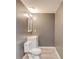 Cozy bathroom with a toilet, vanity, mirror, and neutral walls at 1727 Shire Village Dr, Sugar Hill, GA 30518