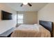 Bedroom featuring neutral paint, carpet flooring, television and ceiling fan at 1727 Shire Village Dr, Sugar Hill, GA 30518