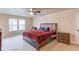 Spacious bedroom with neutral carpet, large windows and a ceiling fan at 1727 Shire Village Dr, Sugar Hill, GA 30518