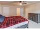 Spacious bedroom featuring a ceiling fan, neutral paint and a large dresser at 1727 Shire Village Dr, Sugar Hill, GA 30518