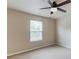 Bright bedroom with ceiling fan and window with blinds at 1727 Shire Village Dr, Sugar Hill, GA 30518