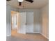 Bedroom featuring neutral paint, carpet flooring and a double door closet at 1727 Shire Village Dr, Sugar Hill, GA 30518