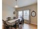 Bright dining room with hardwood floors, classic furniture and window with light curtains at 1727 Shire Village Dr, Sugar Hill, GA 30518
