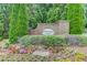 Rivendale Crossing brick entrance sign with flower beds and lush greenery at 1727 Shire Village Dr, Sugar Hill, GA 30518