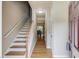 Inviting entryway featuring hardwood floors, staircase, and natural light at 1727 Shire Village Dr, Sugar Hill, GA 30518