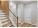 Entry hall with wood stairs and flooring at 1727 Shire Village Dr, Sugar Hill, GA 30518