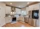 Contemporary kitchen with white cabinetry, stainless steel appliances, and sleek countertops at 1727 Shire Village Dr, Sugar Hill, GA 30518