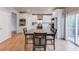 Kitchen features white cabinets, stainless appliances and adjacent dining area with sliding doors to deck at 1727 Shire Village Dr, Sugar Hill, GA 30518