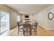 Open concept living room and dining room area with hardwood floors at 1727 Shire Village Dr, Sugar Hill, GA 30518