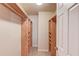 Spacious walk-in closet with built-in wooden shelving and carpeted floor at 1727 Shire Village Dr, Sugar Hill, GA 30518