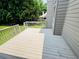 Neutral colored back deck area with stairs leading to the yard and wooded surrounding property at 2640 Preston Ridge Ln, Dacula, GA 30019