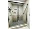 Bathroom with glass shower and sliding doors, tiled surround, and integrated shelving at 2640 Preston Ridge Ln, Dacula, GA 30019