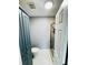 Clean bathroom featuring a glass shower, toilet, and large, blue, storage cabinet at 2640 Preston Ridge Ln, Dacula, GA 30019