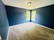 Spacious bedroom features two bright windows, carpet floors, and blue walls at 2640 Preston Ridge Ln, Dacula, GA 30019