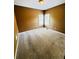 Empty bedroom with caramel colored walls, tan carpet, and two windows at 2640 Preston Ridge Ln, Dacula, GA 30019