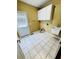 Laundry room featuring tile floors, white cabinets, a sink, and a door at 2640 Preston Ridge Ln, Dacula, GA 30019