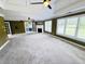 Large living room with fireplace, fan, white trim and neutral carpeting and paint at 2640 Preston Ridge Ln, Dacula, GA 30019