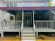 Covered patio with seating, ceiling fans and stairs leading down to backyard at 2640 Preston Ridge Ln, Dacula, GA 30019
