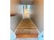 Carpeted staircase leading to a bright upstairs hallway with wood flooring at 2640 Preston Ridge Ln, Dacula, GA 30019