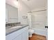 Bathroom featuring a granite countertop, white cabinets, and a shower and tub combo at 2647 Midler Ct, Buford, GA 30519