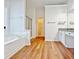 Bright bathroom with a soaking tub, walk-in shower, and granite countertops at 2647 Midler Ct, Buford, GA 30519