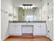 Double vanity in bathroom featuring great lighting, granite countertops, and wood flooring at 2647 Midler Ct, Buford, GA 30519