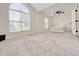 Light-filled bedroom featuring large window and carpeted floors at 2647 Midler Ct, Buford, GA 30519