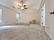 Spacious bedroom with neutral carpet, a ceiling fan, and natural light at 2647 Midler Ct, Buford, GA 30519