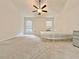 Large bedroom with a ceiling fan, neutral carpet, and large windows at 2647 Midler Ct, Buford, GA 30519