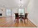 Bright dining room featuring wood floors, a modern chandelier, and large windows at 2647 Midler Ct, Buford, GA 30519