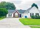 Traditional style home featuring a well-kept lawn, attached garage, and inviting exterior with brick and white siding at 2647 Midler Ct, Buford, GA 30519