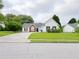 Classic home featuring a green lawn, vinyl siding, brick facade, and a driveway leading to an attached garage at 2647 Midler Ct, Buford, GA 30519