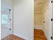 Hallway view to bedroom and bathroom with neutral walls and hardwood floors at 2647 Midler Ct, Buford, GA 30519