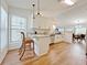 Bright kitchen featuring white cabinets, granite countertops, and stainless steel appliances at 2647 Midler Ct, Buford, GA 30519