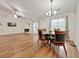Open-concept living and dining area featuring hardwood floors, a fireplace, and a ceiling fan at 2647 Midler Ct, Buford, GA 30519